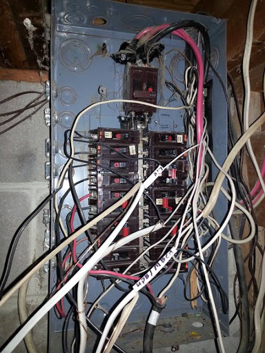 poorly organized breaker panel before it was corrected